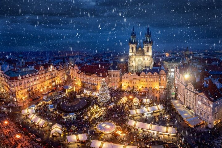 Wander through the sparkling Old Town Square with its grand architecture and festive markets as snowflakes gently fall creating a magical winter scene in Prague.